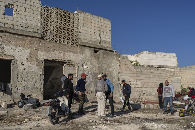 ARCHIVO - Una familia es recibida por vecinos locales tras regresar a su casa en un vecindario de Maarat al-Numan, a las afueras de Idlib, Siria, el miércoles 15 de enero de 2025. (AP Foto/Mosaab Elshamy, Archivo)