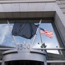 La bandera estadounidense junto a una asta vacía que sostenía la bandera de la Agencia de los Estados Unidos para el Desarrollo Internacional (USAID, por sus siglas en inglés), se refleja en una ventana que mostraba el nombre y el sello de la USAID, fuera de las oficinas de la agencia en Washington, el viernes 7 de febrero de 2025. (AP Foto/Jose Luis Magana)