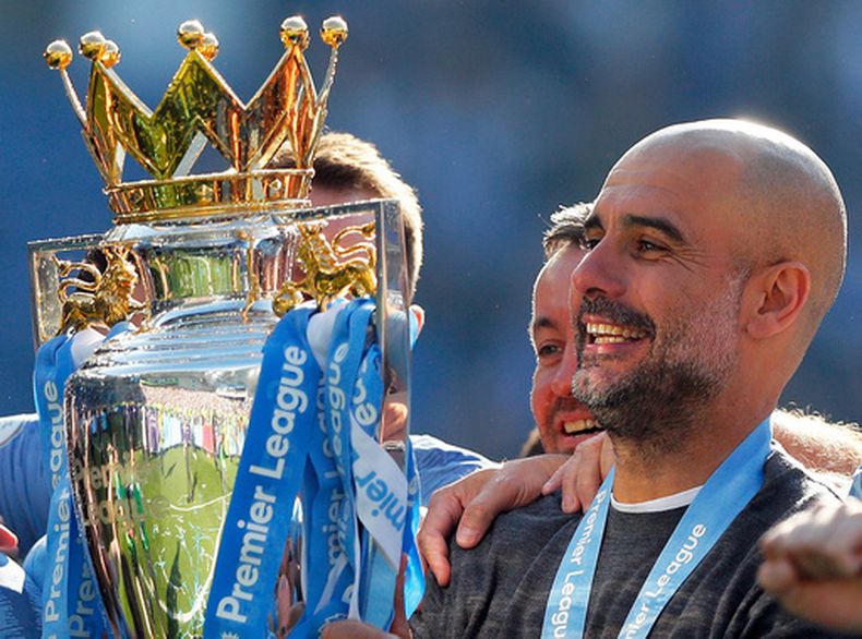 ARCHIVO - El técnico del Manchester City Pep Guardiola alza el trofeo de la Liga Premier tras el partido contra Brighton, el domingo 12 de mayo de 2019, en Brighton. (AP Foto/Frank Augstein)