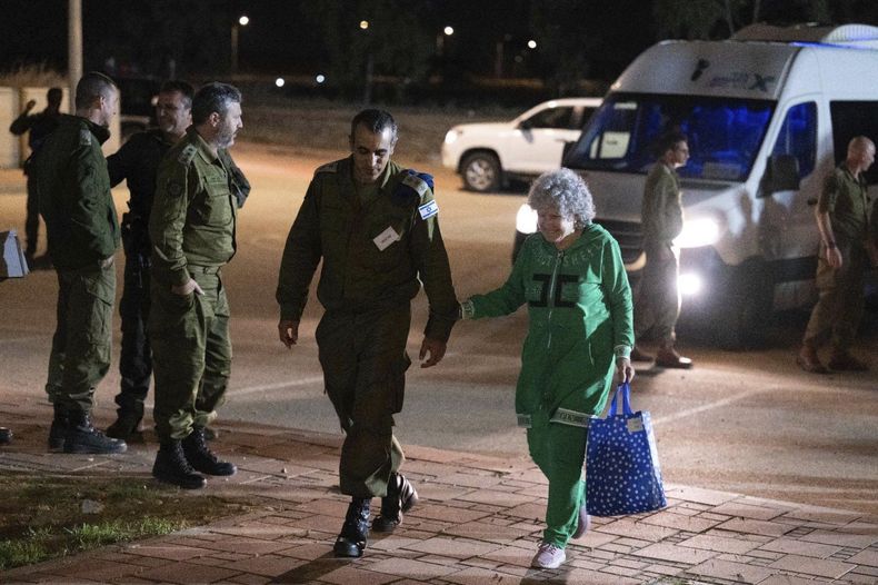 Ruth Munder, una rehén israelí liberada, camina junto a un soldado israelí poco después de su llegada a Israel el viernes 24 de noviembre de 2023. (Fuerzas de Defensa de Israel via AP)