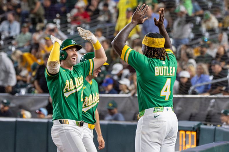 Jeff McNeil, de los Atléticos de Oakland, intercambia palmadas con Lawrence Butler, tras conectar un jonrón ante los Rangers de Texas, el viernes 14 de agosto de 2026 (AP Foto/Sara Nevis)