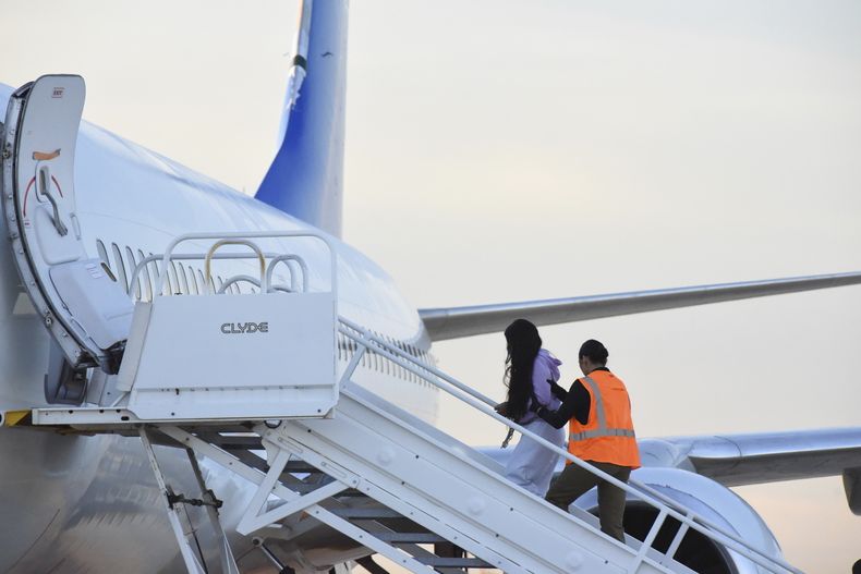 ARCHIVO - Migrantes venezolanos abordan un avión que se dirige a su país natal, el miércoles 18 de octubre de 2023, en Harlingen, Texas. (AP Foto/Valerie Gonzalez, Archivo)