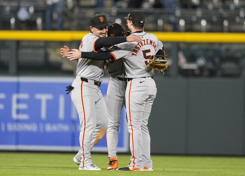 De izquierda a derecha, el jardinero izquierdo de los Gigantes de San Francisco, Michael Conforto, el jardinero central Jung Hoo Lee y el jardinero derecho Mike Yastrzemski celebran después del partido de béisbol contra los Rockies de Colorado, el martes 7 de mayo de 2024, en Denver. (AP Foto/David Zalubowski)