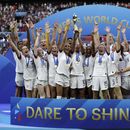 ARCHIVO - Las jugadores de Estados Unidos alzan el trofeo de campeones del mundo tras vencer a Holanda en la final de la Copa Mundial, el 7 de julio de 2019, en Decines, Francia. (AP Foto/Alessandra Tarantino)