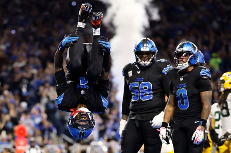Jameson Williams (1), receptor abierto de los Lions de Detroit, da un salto mortal después de atrapar un pase de anotación durante la segunda mitad del partido de la NFL en contra de los Packers de Green Bay, el domingo 25 de octubre de 2026, en Detroit. (AP Foto/Rey Del Rio)