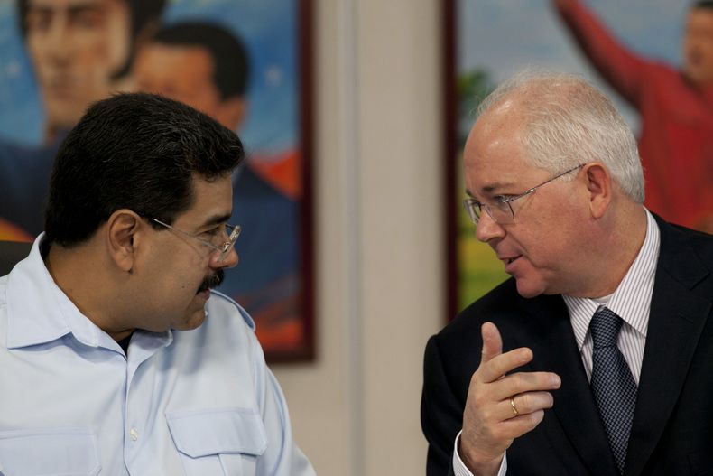 ARCHIVO - En esta foto del 15 de noviembre de 2013, el presidente de Venezuela, Nicol&aacute;s Maduro, a la izquierda, habla con su ministro del Petr&oacute;leo, Rafael Ram&iacute;rez, antes del inicio de una conferencia de prensa en el palacio presidenci