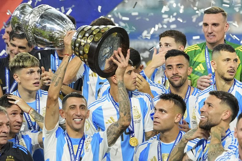 Angel Di Maria celebra con el trofeo de campeón de la Copa América tras superar a Colombia en la final el domingo 14 de julio del 2024. (AP Foto/Julio Cortez)