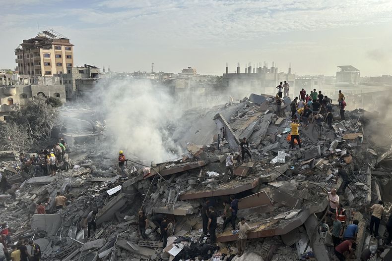 Palestinos buscan sobrevivientes tras un ataque aéreo israelí sobre el campo de refugiados de Nusseirat, en la Franja de Gaza, el 31 de octubre de 2023. (AP Foto/Doaa AlBaz)