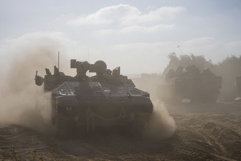 Vehículos blindados israelíes, vistos en la frontera entre Israel y la Franja de Gaza durante la campaña terrestre militar israelí en el enclave palestino, el 8 de noviembre de 2023. (AP Foto/Ohad Zwigenberg)