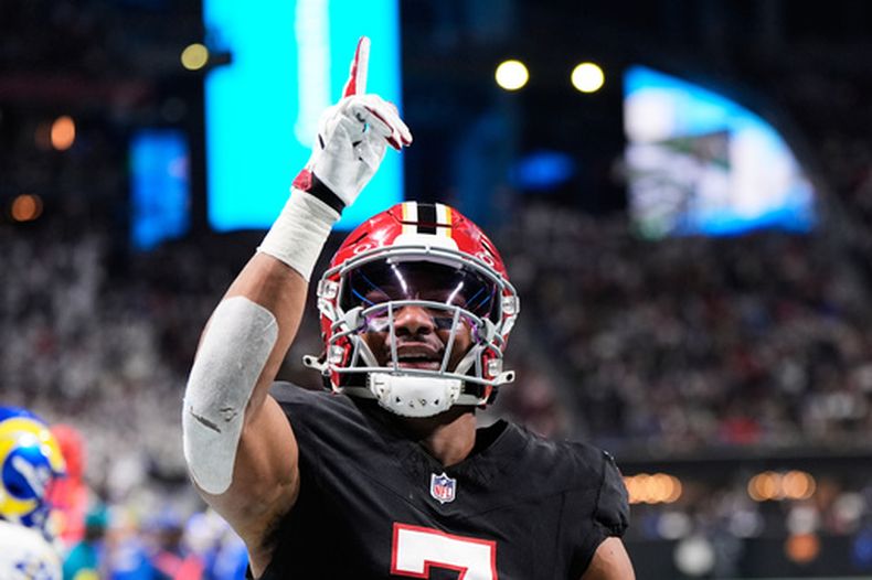 ARCHIVO - El corredor de los Falcons de Atlanta, Bijan Robinson (7), celebra su recepción para touchdown contra los Rams de Los Ángeles en la primera mitad de un partido de fútbol americano de la NFL, el 29 de diciembre de 2025, en Atlanta. (Foto AP/Brynn Anderson, Archivo)