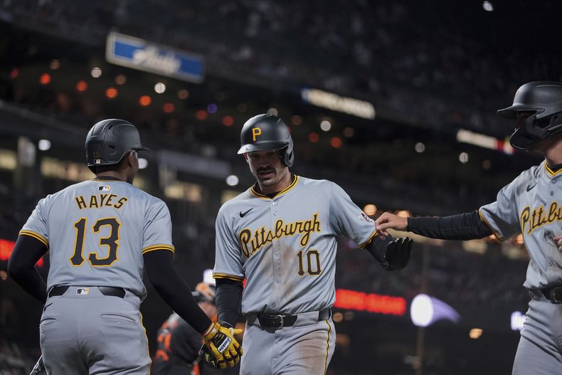 Bryan Reynolds de los Piratas de Pittsburgh celebra con sus compañeros KeBryan Hayes y Alika Williams tras batear un jonrón de dos carreras ante los Gigantes de San Francisco en la décima entrada del sábado 27 de abril del 2024. (AP Foto/Godofredo A. Vásquez)