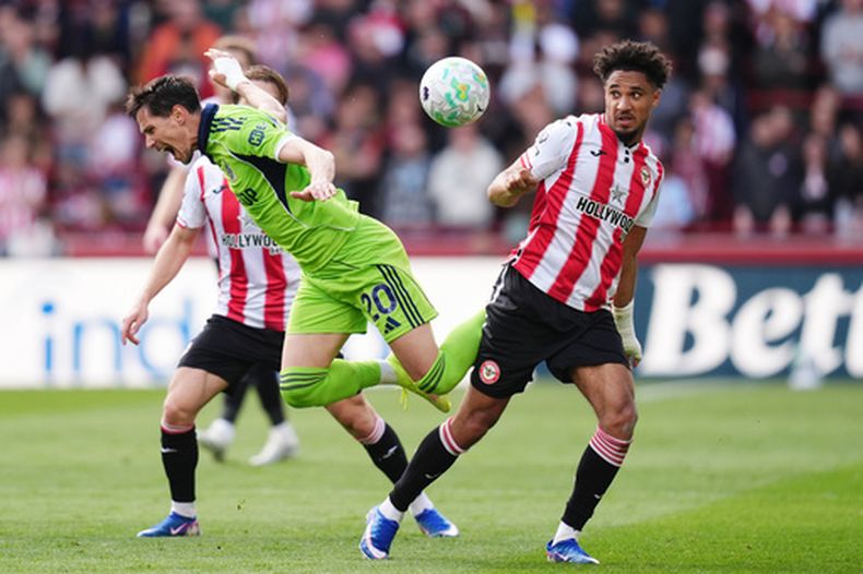 Sasa Lukic del Fulham, a la izquierda, y Kevin Schade del Brentford luchan por el balón durante el partido de fútbol de la Liga Premier inglesa entre el Brentford y el Fulham en Brentford, Inglaterra, el sábado 18 de abril de 2026. (John Walton/PA vía AP)