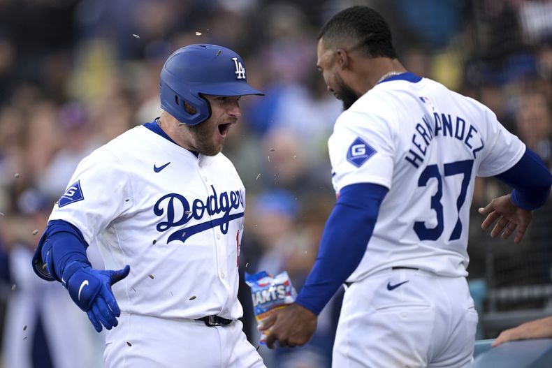 Max Muncy de los Dodgers de Los Ángeles (izquierda) celebra junto al dominicano Teoscar Hernández luego de conectar un jonrón de dos carreras en la octava entrada del juego de béisbol ante los Cardenales de San Luis, el domingo 31 de marzo de 2024, en Los Ángeles. (AP Foto/Jayne-Kamin-Oncea)