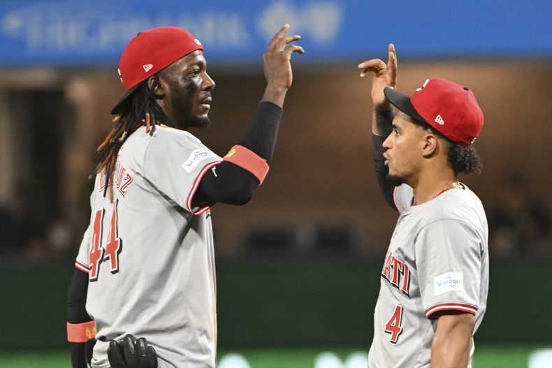 El campocorto de los Rojos de Cincinnati, Elly De La Cruz, izquierda, celebra con el tercera base Santiago Espinal después de derrotar a los Piratas de Pittsburgh 10-2, el sábado 24 de agosto de 2024, en Pittsburgh. (Foto AP/Barry Reeger)