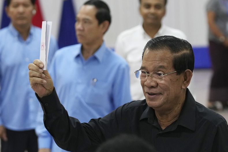 ARCHIVO – El ex primer ministro camboyano, Hun Sen, al frente, del gobernante Partido Popular de Camboya, muestra una boleta antes de votar en una elección del Senado en el centro de votación de Takhmau en la provincia de Kandal, en el sureste de Nom Pen, Camboya, el domingo 25 de febrero de 2024. (AP Photo/Heng Sinith, Archivo)