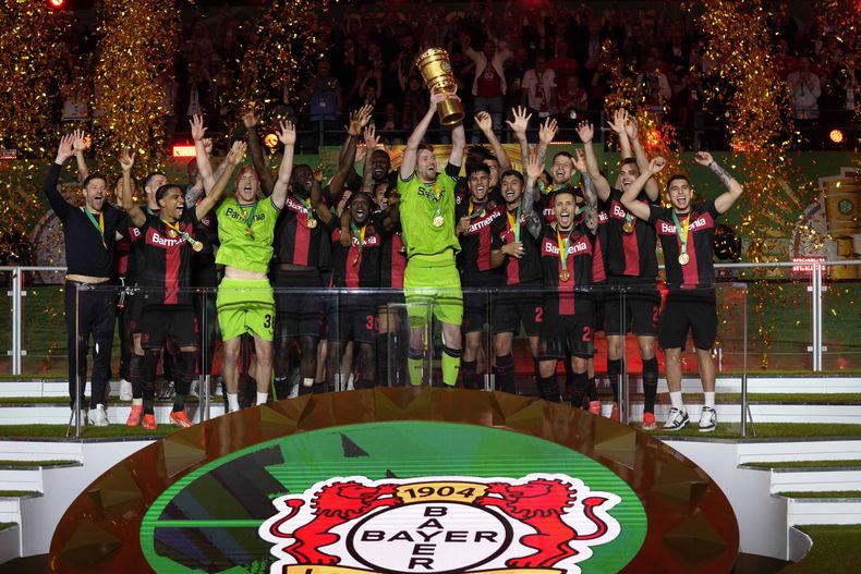 Jugadores del Bayer Leverkusen celebran con el trofeo tras ganar la final de la Copa Alemana al vencer al Kaiserslaustern el sábado 25 de mayo del 2024. (AP Foto/Matthias Schrader)