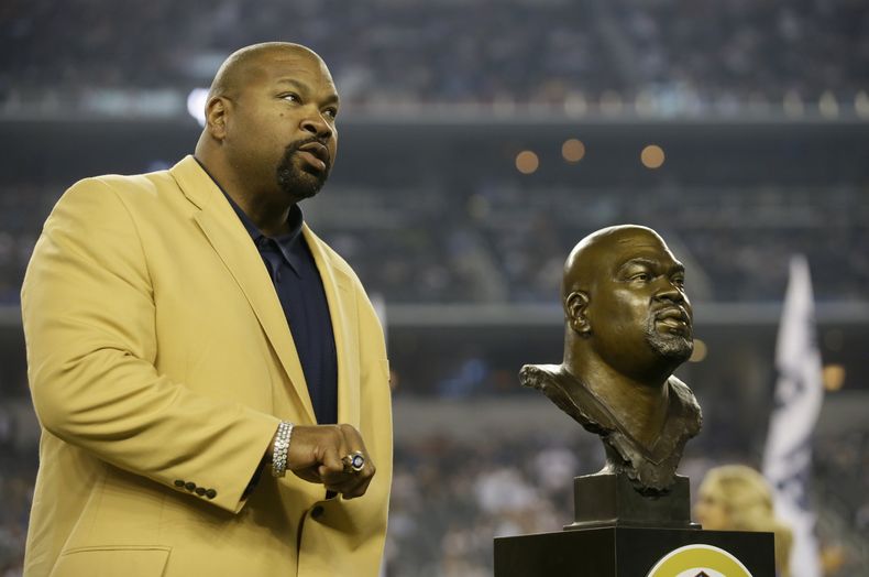 ARCHIVO - Larry Allen, miembro del Salón de la Fama de los Cowboys de Dallas, muestra su anillo del Salón de la Fama, durante el entretiempo de un partido de la NFL, el 13 de octubre de 2013, en Arlington, Texas. Allen, uno de los linieros ofensivos más dominantes en la NFL durante sus 12 años de carrera, que pasó la mayor parte con los Cowboys, murió de súbito el domingo 2 de junio de 2024 mientas estaba de vacaciones con su familia en México, informaron los Cowboys. Tenía 52 años. (AP Foto/Tim Sharp, Archivo)