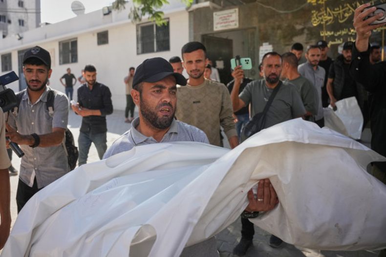 Dolientes cargan con los cuerpos de dos niñas palestinas, Zeina Safadi y su hermana Lana, que murieron durante un ataque nocturno israelí que dañó su casa, durante su funeral en la Ciudad de Gaza, el 20 de junio de 2026. (AP Foto/Abdel Kareem Hana)