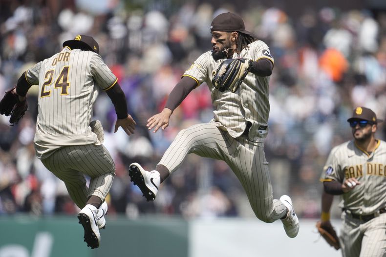 Rougned Odor (24) y Fernando Tatis Jr. de los Padres de San Diego celebran la victoria ante los Gigantes de San Francisco, el jueves 22 de junio de 2023. (AP Foto/Jeff Chiu)
