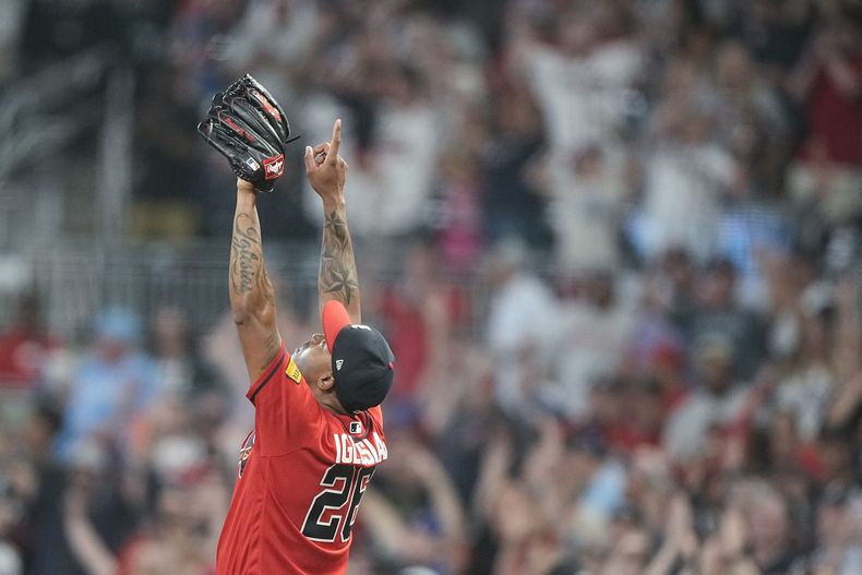 El cubano Raisel Iglesias, relevista de los Bravos de Atlanta, festeja el triunfo sobre los Nacionales de Washington, el viernes 9 de junio de 2023 (AP Foto/Brynn Anderson)