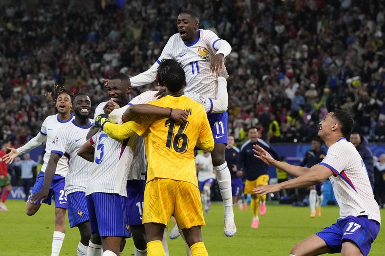 Los jugadores de Francia festejan tras vencer a Portugal por penales en los cuartos de final de la Eurocopa, el viernes 5 de julio de 2024, en Hamburgo, Alemania (AP Foto/Hassan Ammar)