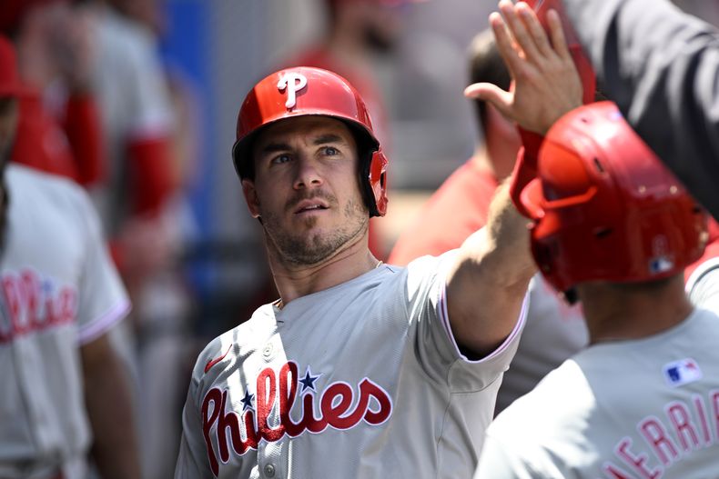 J.T. Realmuto de los Filis de Filadelfia saluda a sus compañeros tras anotar junto a Whit Merrifield con el sencillo remolcador de Kyle Schwarber ante los Angelinos de Los Ángeles el miércoles 1 de mayo del 2024. (AP Foto/Alex Gallardo)