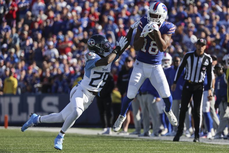 Amari Cooper (18), de los Bills de Buffalo, atrapa un pase para un primero y diez, superando la cobertura de Jarvis Brownlee Jr. (29), de los Titans de Tennessee, durante la segunda mitad del juego de la NFL del domingo 20 de octubre de 2024, en Orchard Park, Nueva York. (AP Foto/Jeffrey T. Barnes)