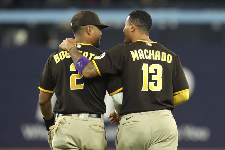 El dominicano Manny Machado y Xander Bogaerts, de los Padres de San Diego, avanzan para colocarse en sus posiciones en el juego del miércoles 19 de julio de 2023, ante los Azulejos de Toronto (Chris Young/The Canadian Press via AP)