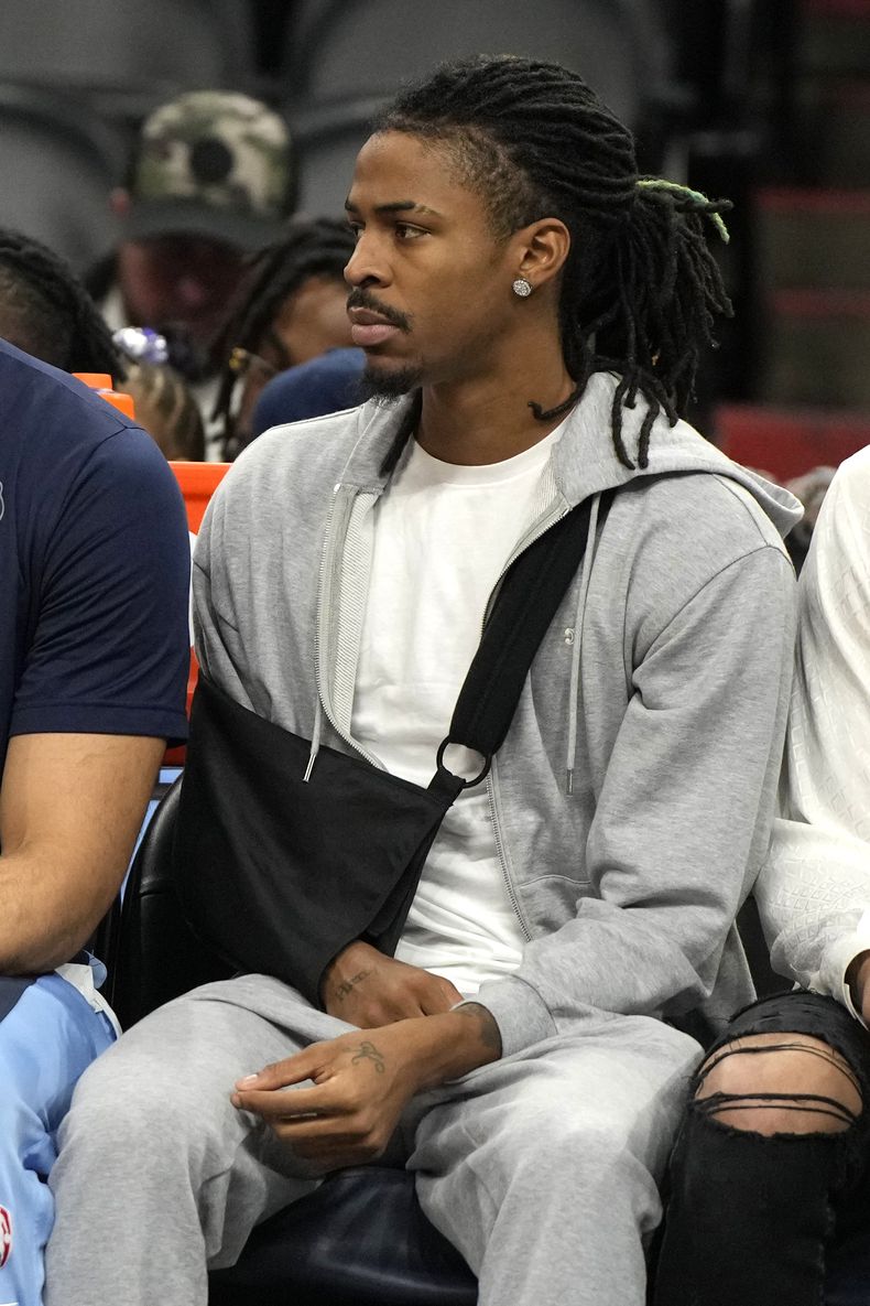 El base de los Grizzlies de Memphis Ja Morant con el brazo en un cabestrillo sentado en la banca en el encuentro ante los Suns de Phoenix el domingo 7 de enero dle 2024. (AP Foto/Rick Scuteri)