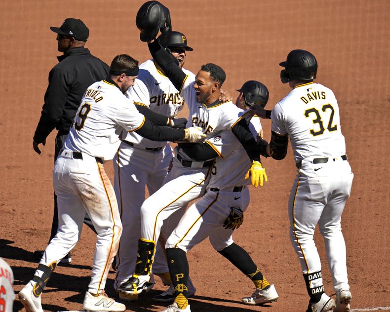 Edward Olivares (centro) de los Piratas de Pittsburgh celebra tras remolcar la carrera del triunfo ante los Orioles de Baltimore, el domingo 7 de abril de 2024. (AP Foto/Gene J. Puskar)