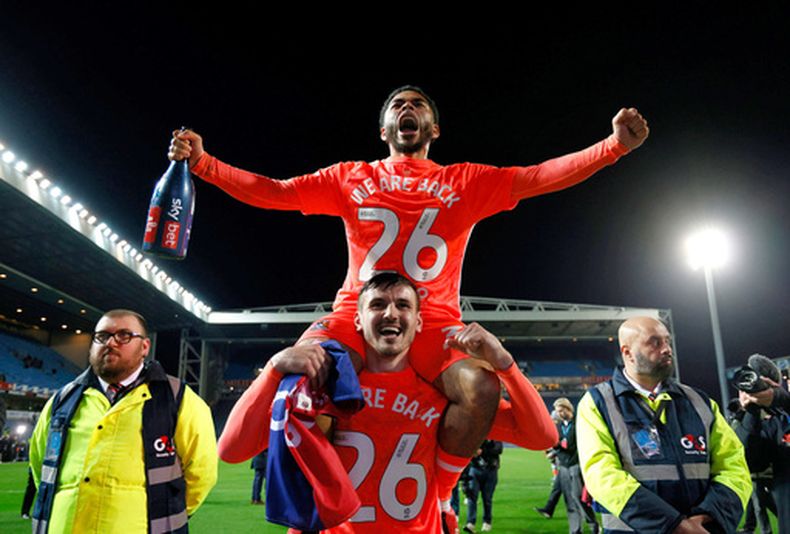 Jay Dasliva (arriba), del Coventry City, es levantado en hombros por Bobby Thomas para celebrar el ascenso a la Liga Premier inglesa, luego de empatar ante Blackburn, el viernes 17 de abril de 2026 (Richard Sellers/PA via AP)