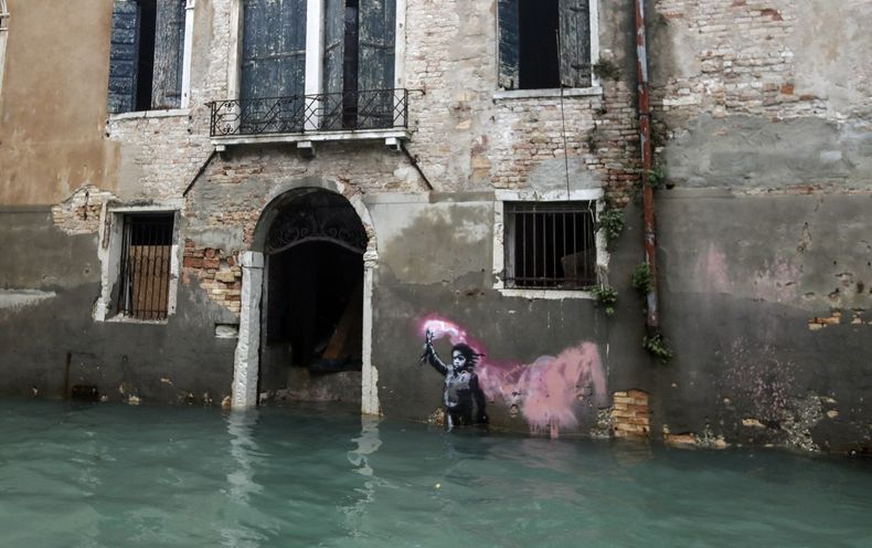 ARCHIVO - La obra de Bansky The Migrant Child parcialmente sumergida en Venecia, Italia, el 15 de noviembre de 2019. (Foto AP/Luca Bruno, archivo)