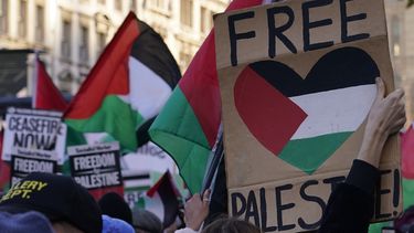 Manifestantes con banderas y pancartas realizan una manifestación propalestina en Whitehall, la calle de los edificios de gobierno en Londres, sábado 25 de noviembre de 2023. (AP Foto/Alberto Pezzali)