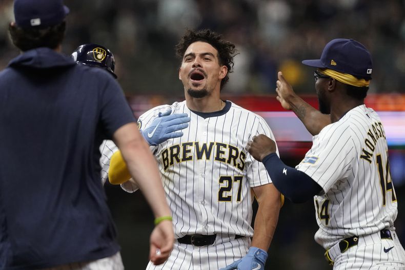 Willy Adames de los Cerveceros de Milwaukee felicitado por sus compañeros tras el sencillo remolcador de la victoria en la décima entrada ante los Medias Blancas de Chicafgo el sábado primero de junio del 2024. (AP Foto/Aaron Gash)