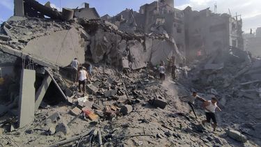 Palestinos inspeccionan los daños en los edificios destruidos por ataques aéreos israelíes contra el campo de refugiados de Jabaliya, a las afueras de la Ciudad de Gaza, el 31 de octubre de 2023 (AP Foto/Abdul Qader Sabbah)