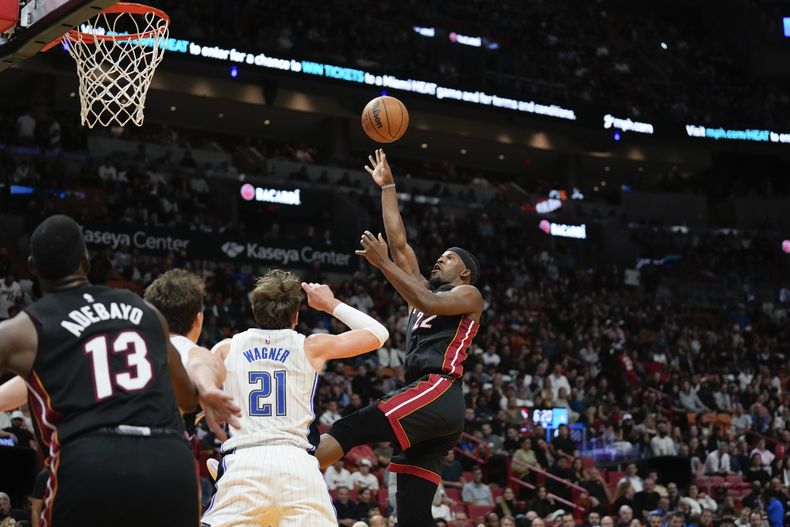 Jimmy Butler, del Heat de Miami, dispara frente a Moritz Wagner, del Magic de Orlando, en el encuentro del martes 6 de febrero de 2024 (AP Foto/Rebecca Blackwell)