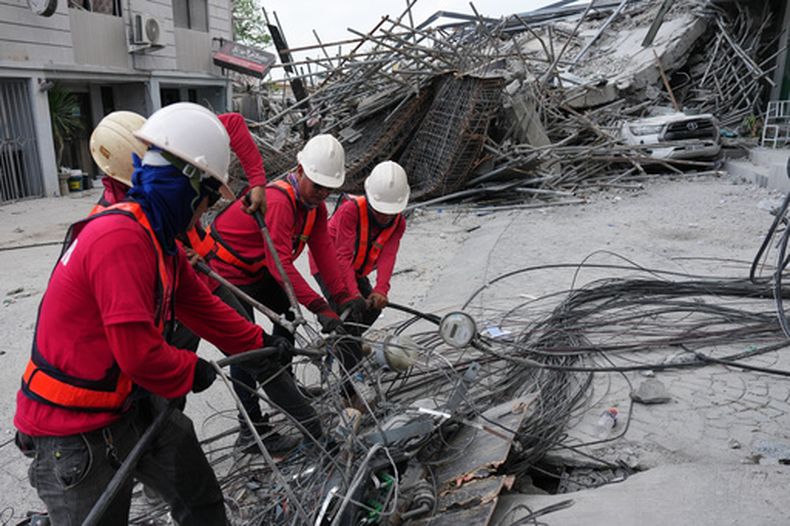 Trabajadores cortan cables durante una operación de búsqueda en un edificio derruido donde se cree que ha varias personas atrapadas, en Ángeles, en la provincia de Pampanga, al norte de Manila, Filipinas, el lunes 25 de mayo de 2026. (AP Foto/Aaron Favila)
