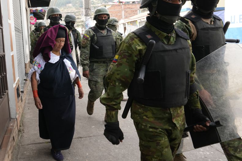 Agentes de policía llegan para proteger el Colegio Jacinto Collahuazo, donde el presidente Daniel Noboa asiste a un evento para entregar beneficios y condenar las protestas contra el aumento del precio del diésel tras los recortes a los subsidios a los combustibles, en Otavalo, Ecuador, el miércoles 24 de septiembre de 2025. (Foto AP/Dolores Ochoa)