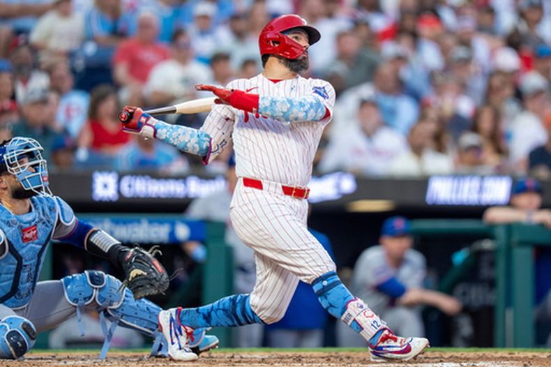 Kyle Schwarber (derecha), de los Filis de Filadelfia, conecta un jonrón de tres carreras durante la segunda entrada de un partido de béisbol contra los Mets de Nueva York, el domingo 21 de junio de 2026, en Filadelfia. (Foto AP/Chris Szagola)