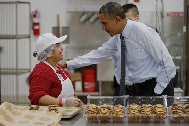 El presidente Barack Obama saluda a la empleada de la pasteler&iacute;a en un Costco de Maryland, el 29 de enero de 2014. Durante esa visita, el mandatario habl&oacute; de la necesidad de elevar el salario m&iacute;nimo. (Foto AP/Charles Dharapak)