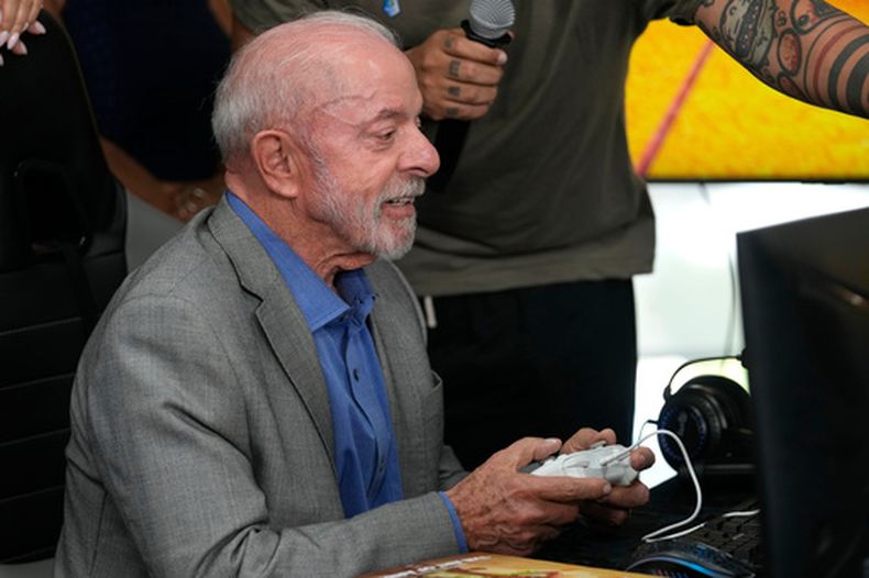 El presidente de Brasil, Luiz Inácio Lula da Silva, juega un videojuego brasileño antes de una ceremonia para firmar un decreto que regula la industria de los videojuegos en Brasilia, Brasil, el miércoles 14 de octubre de 2026. (AP Foto/Eraldo Peres)
