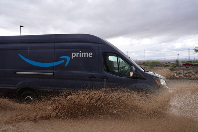 Un conductor de entregas atraviesa un camino inundado el viernes 30 de octubre de 2026, en Henderson, Nevada. (AP Foto/Ty ONeil)