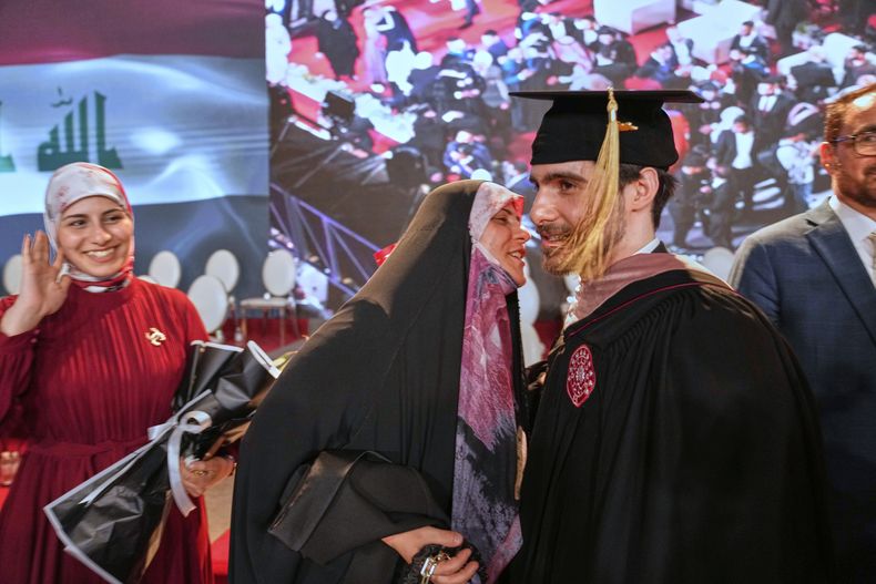 Una madre iraquí celebra con su hijo en la primera ceremonia de graduación de la Universidad Estadounidense de Irak en Bagdad, Irak, el sábado 24 de mayo de 2025. (AP Foto/Hadi Mizban)