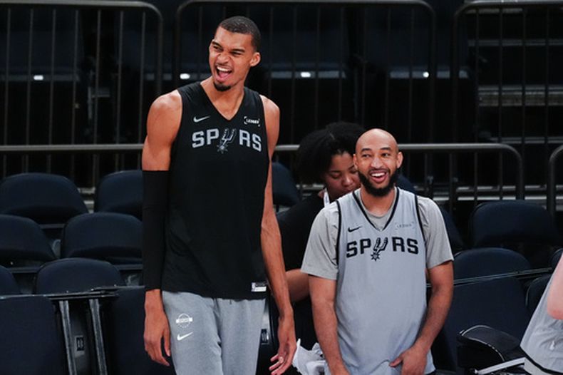 Victor Wembanyama, izquierda, de los Spurs de San Antonio, se ríe durante el entrenamiento previo al tercer juego de las Finales de la NBA, el domingo 7 de junio de 2026, en Nueva York. (AP Foto/Ross D. Franklin)