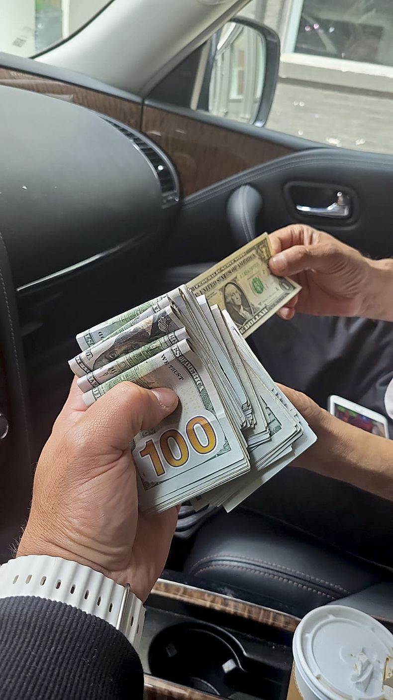 En esta fotografía de junio de 2023 tomada por un agente encubierto y proporcionada por fiscales de EEUU, se ve a un agente encubierto que se hace pasar por un sicario, a la izquierda, guardando dinero recibido como anticipo para cometer un asesinato, durante una transacción en Nueva York. Según la acusación, Nikhil Gupta, de 52 años, un ciudadano indio, enfrenta cargos por este caso, se informó, el lunes 17 de junio de 2024. (Foto, Fiscalía de Estados Unidos vía AP, Archivo)