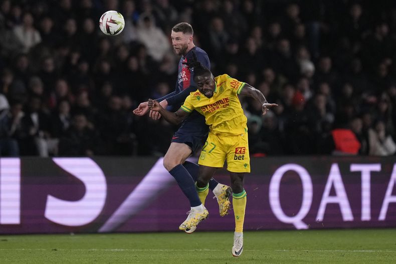 Milan Skriniar del Paris Saint-Germain pelea por el balón con Moses Simon del Nantes en el encuentro de la liga francesa el sábado 9 de diciembre del 2023. (AP Foto/Thibault Camus)