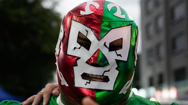 Un fanático de la lucha, con una máscara roja, verde y blanca, antes de entrar al México Arena, en la Ciudad de México, el 26 de junio de 2026. (AP Foto/Marco Ugarte)