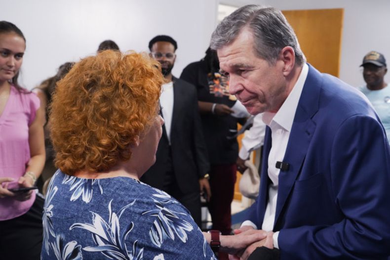 El exgobernador demócrata Roy Cooper, que se postula para el Senado de Estados Unidos, se da la mano con una mujer después de un acto de campaña en la Iglesia Africana Metodista Episcopal St. James en Goldsboro, Carolina del Norte, el jueves 10 de septiembre de 2026. (AP Foto/Allen G. Breed)