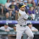 Ramón Laureano, de los Atléticos de Oakland, observa su sencillo productor de una carrera en contra del abridor de los Rockies de Colorado, Kyle Freeland, durante la primera entrada del juego de béisbol, el viernes 28 de julio de 2023, en Denver. (AP Foto/David Zalubowski)