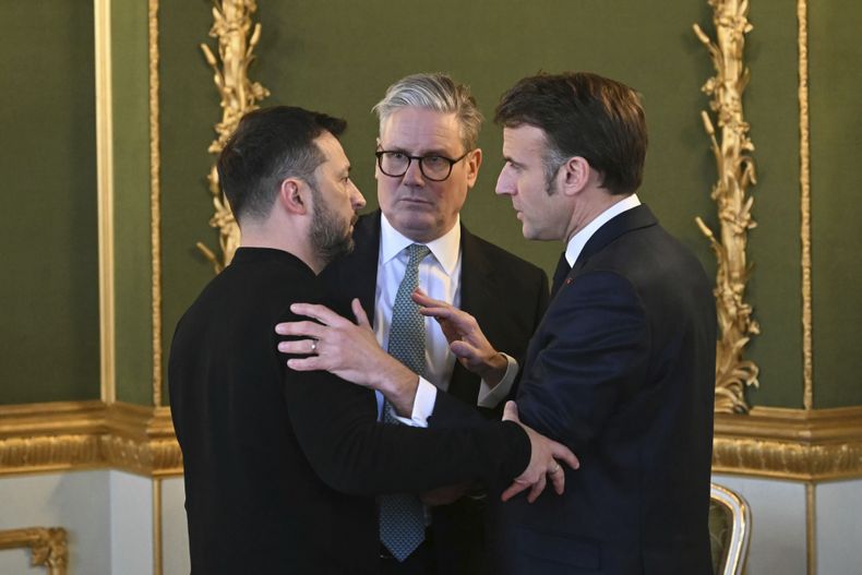 El primer ministro británico Keir Starmer, al centro, el mandatario ucraniano Volodymyr Zelenskyy, a la izquierda, y el presidente francés Emmanuel Macron dialogan durante una cumbre de gobernantes europeos sobre la guerra en Ucrania, en Lancaster House, el domingo 2 de marzo de 2025, en Londres. (Justin Tallis/Foto compartida vía AP)